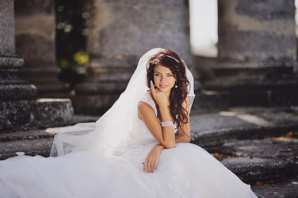 bride posing on the steps of an old church